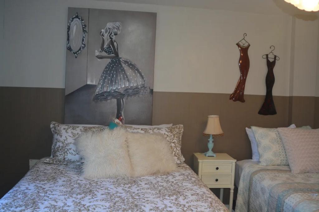 Bedroom with fashion artwork and two beds
