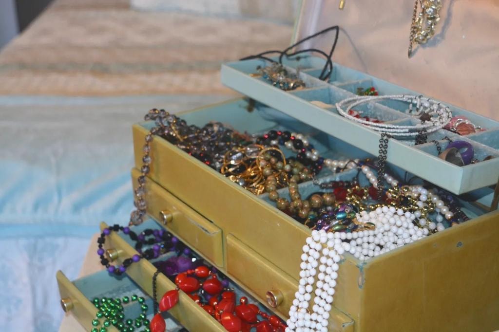 Vintage jewelry box with colorful beads and necklaces